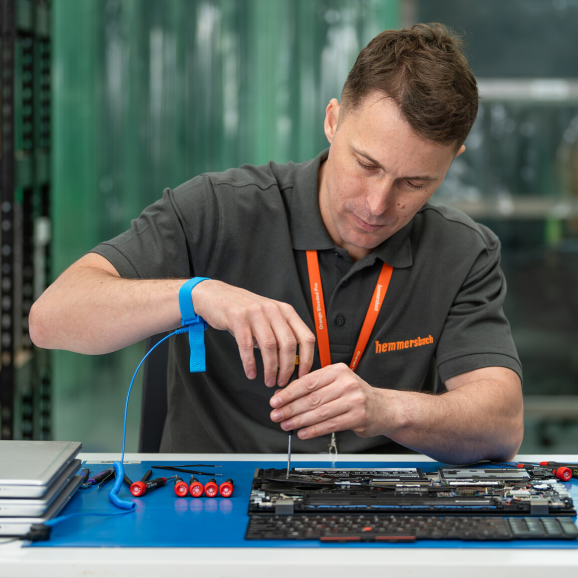 Depot services, laptop repair technician repairing hardware in a depot