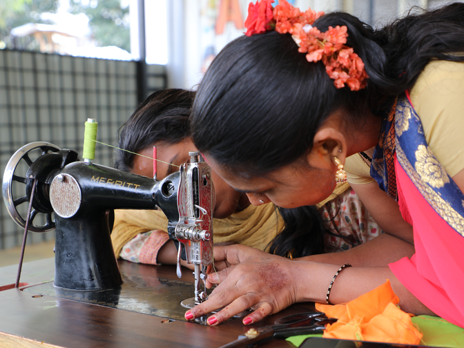 two people sewing